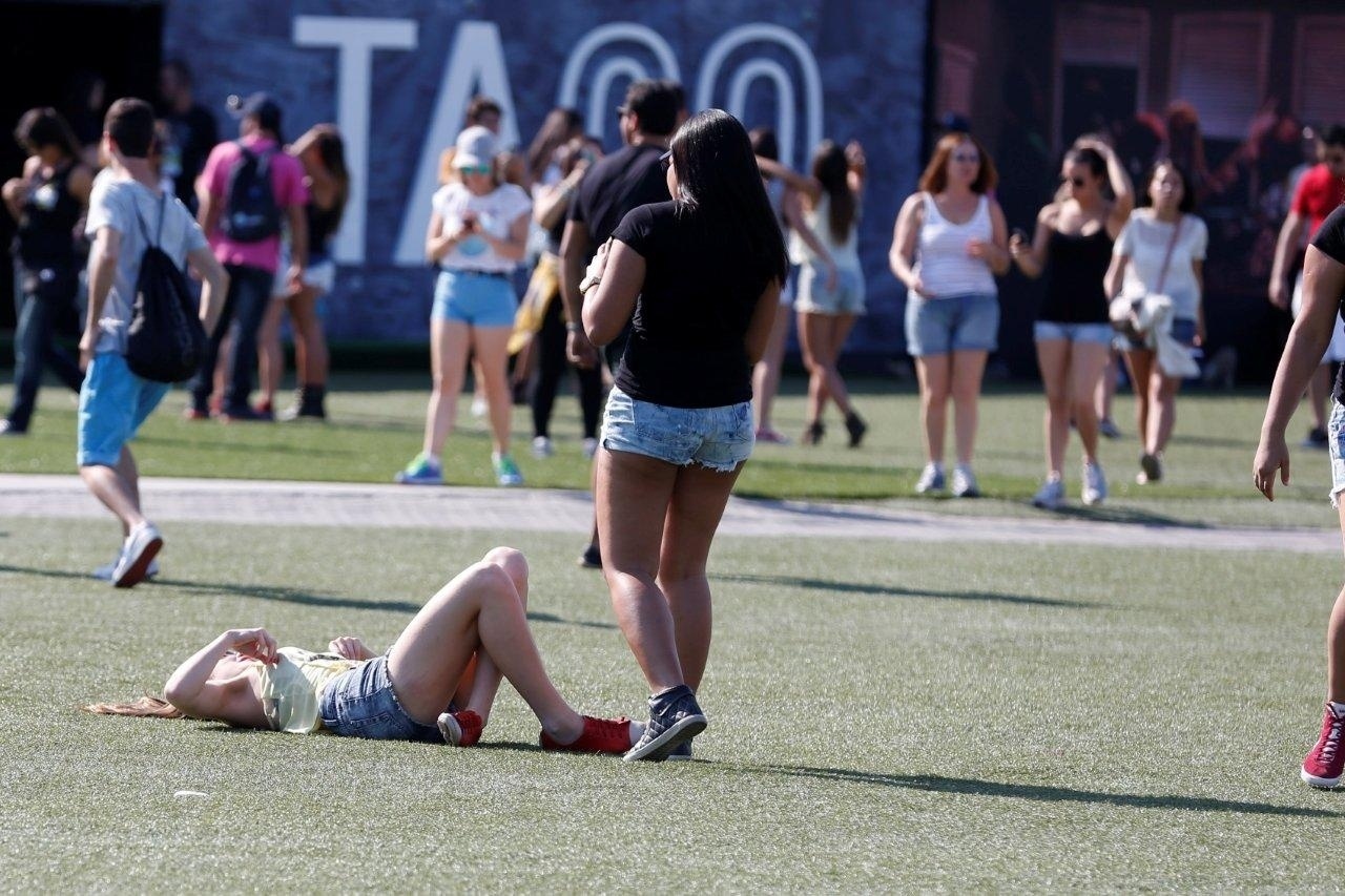 13.set.2013 - Jovem descansa no gramado da Cidade do Rock debaixo de sol forte - Andre Muzell/AgNews