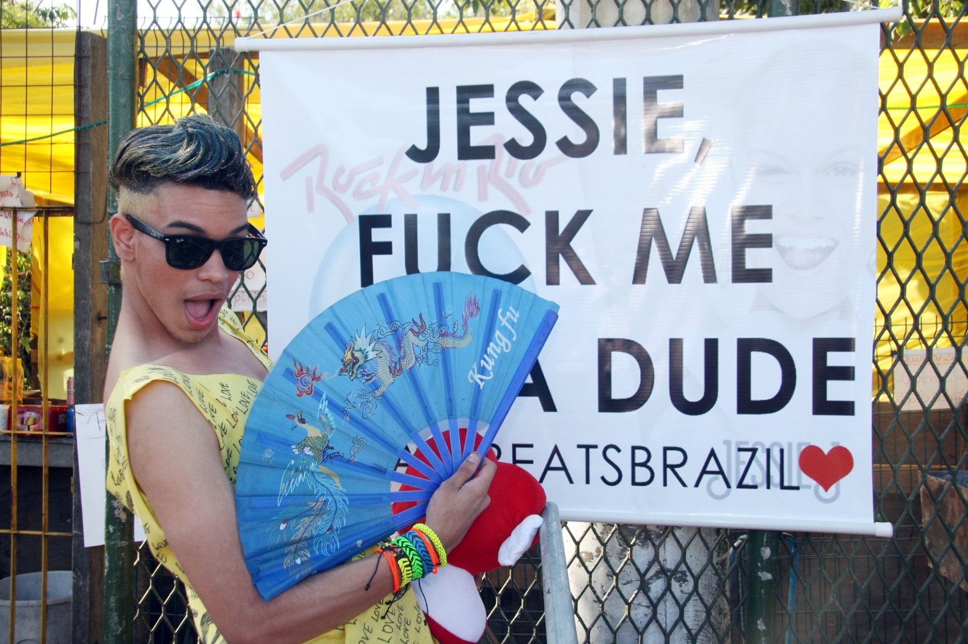 15.set.2013 - O estudante Raí Paulo da Gama, de 20 anos, faz pose ao lado de cartaz para Jessie J na fila do Rock in Rio - Zulmair Rocha/UOL
