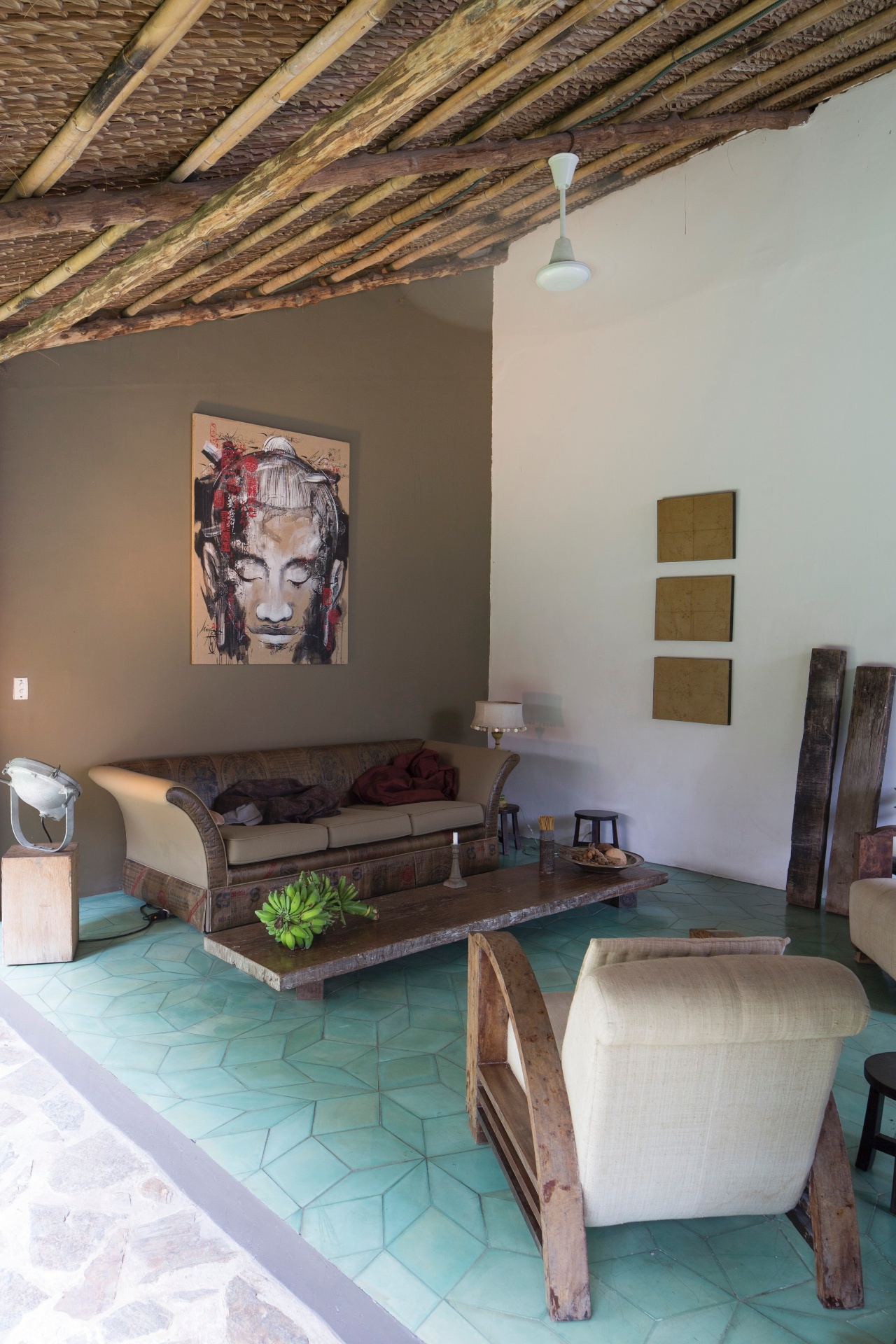 (Imagem do NYT, usar apenas no respectivo material) A longa e baixa mesa de centro foi feita à partir de uma tradicional cama de madeira vietnamita. Na varanda ainda estão um sofá comprado em um antiquário local e um par de poltronas revestidas por tecido também vietnamita - Marcel Lam/ The New York Times