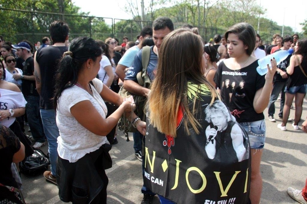 20.set.2013 - Fãs compram bebidas de ambulantes enquanto aguardam abertura dos portões da Cidade do Rock - Zulmair Rocha/UOL