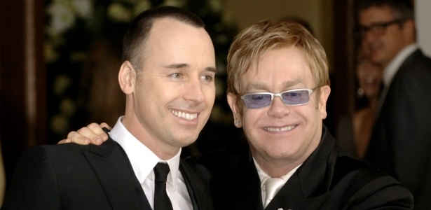 O cantor britânico Elton John (à direita) ao lado do produtor David Furnish, após cerimônia da união civil dos dois em Windsor, no subúrbio de Londres em 2005