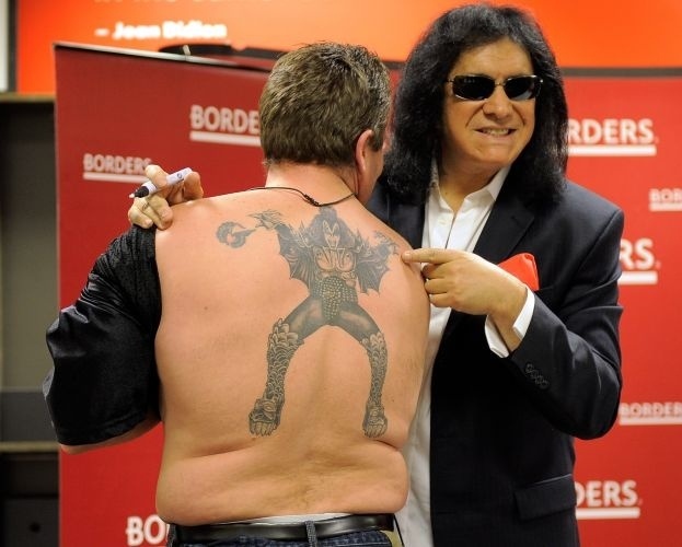 O fã Jeff Smith mostra ao músico Gene Simmons, do Kiss, a tatuagem que fez do artista nas costas durante promoção do "KISS Kompendium", no Borders Books & Music, em Nova York (17/12/2009).