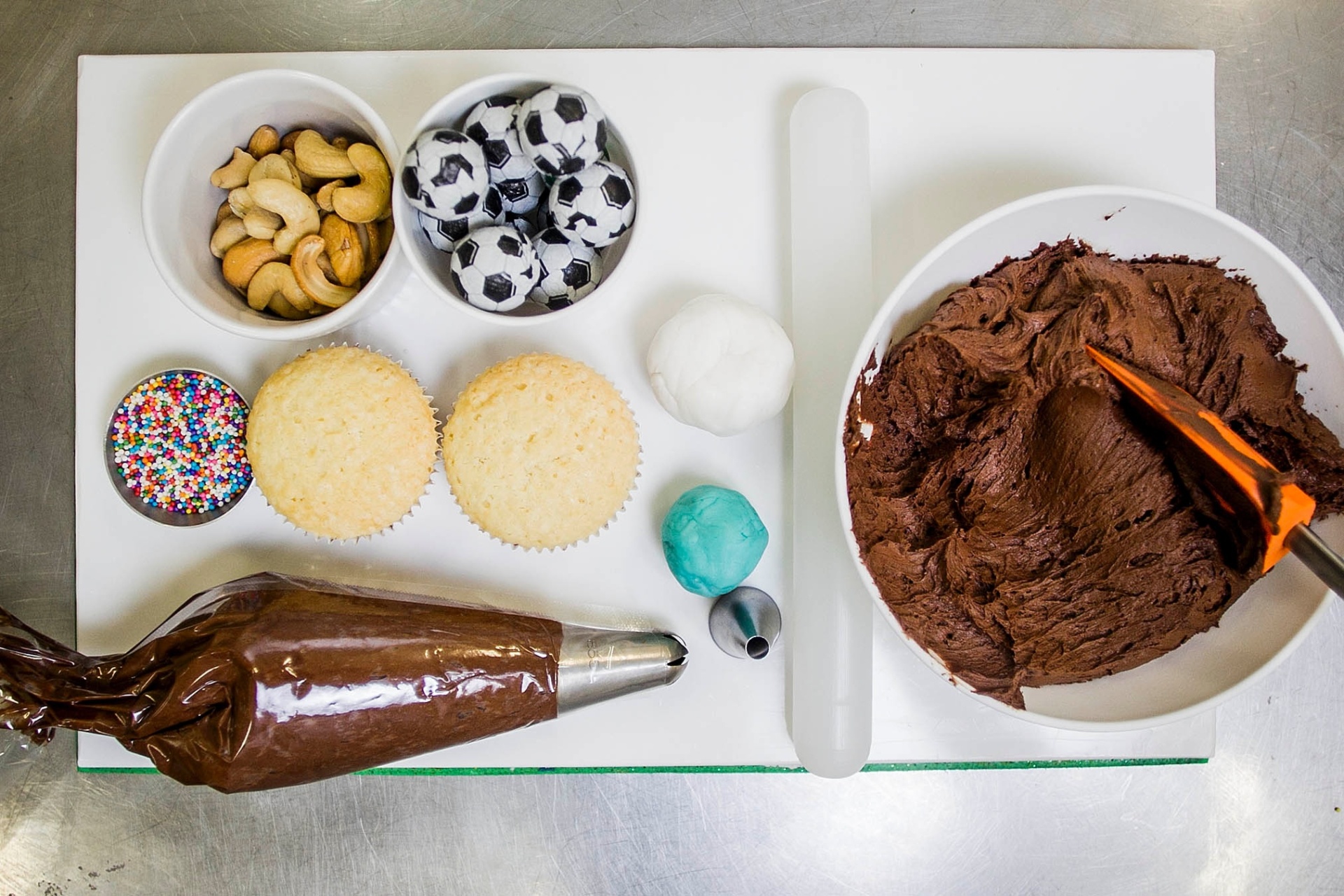 Os cupcakes de coruja e com bola de futebol em cima são os preferidos dos meninos na Luana Davidson Confeitaria. Para fazer essas finalizações do bolinho, você vai precisar de: cupcakes prontos e frios, ganache de chocolate, castanha de caju, bolinhas de chocolate embaladas como bola de futebol, confeito colorido (miçanga), pasta americana em duas cores diferentes, rolo para abrir massa, saco de confeiteiro com bico para confeitar e cortador de, aproximadamente, dois centímetros de diâmetro - Leonardo Soares/UOL