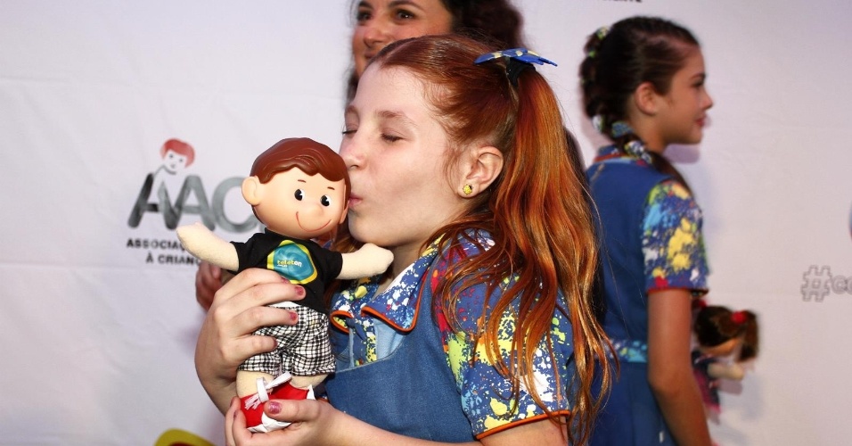 26.out.2013 - A atriz Giulia Garcia, intérprete de Ana em "Chiquititas", beija boneco oficial da campanha