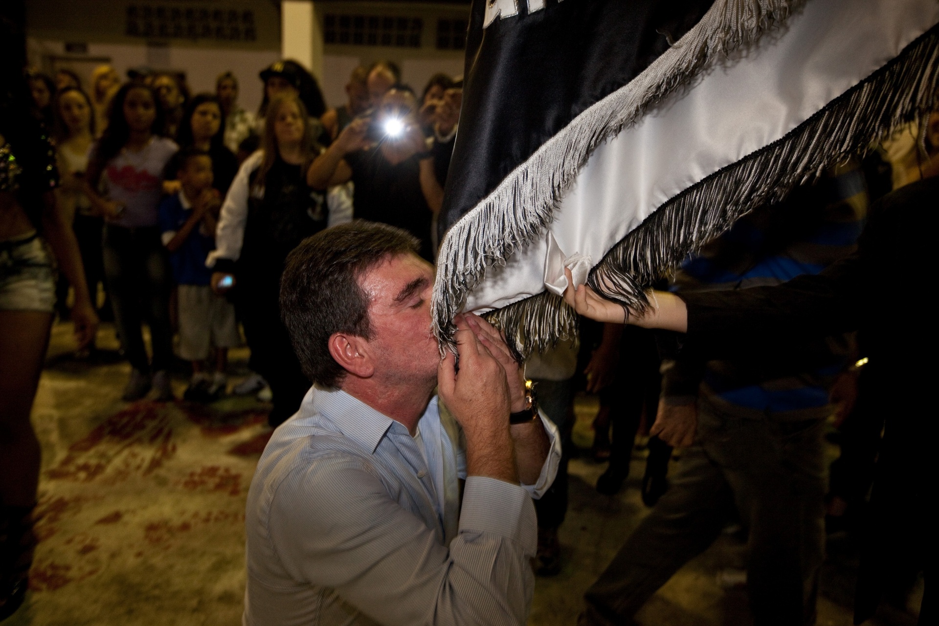1.nov.2013 - O ex-presidente do Corinthians Andres Sanches beija a bandeira da escola na quadra da Gaviões da Fiel - Simon Plestenjak/UOL
