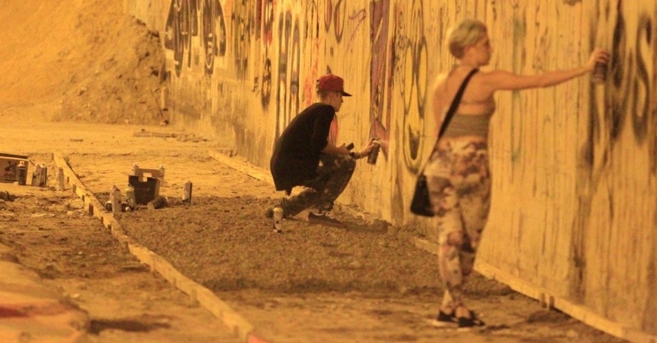 5.nov.2013 - Justin Bieber grafita muro do bairro de São Conrado, no Rio de Janeiro, durante a madrugada. O cantor e sua equipe foram para o local por volta das 3h. De acordo com a agência de fotografias AgNews, os fotógrafos presentes no local foram agredidos pelos seguranças de Bieber e a polícia chegou a ser chamada. O astro teen ficou grafitando por cerca de três horas e atendeu a fãs
