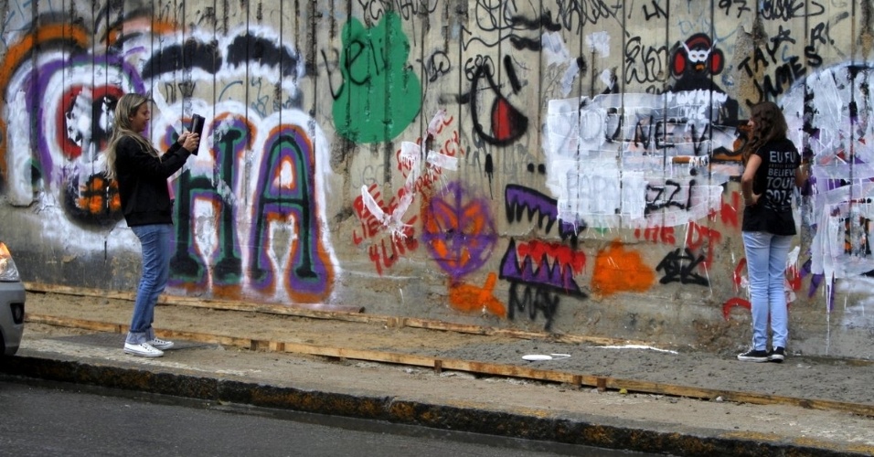 5.nov.2013 - Fãs foram ao local tirar fotos com os desenhos, mas ficaram inconformados com os grafites cobertos e brigaram com os fotógrafos que fizeram o estrago