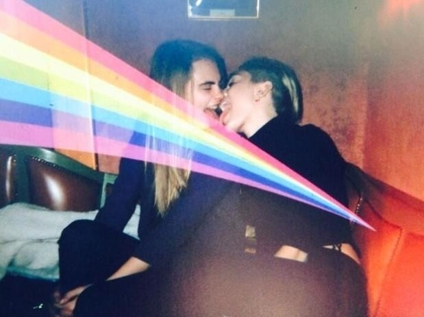 27.dez.2013 - Miley Cyrus e Cara Delevingne se beijam de língua