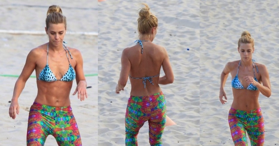 24.fev.2014- Carolina Dickmann exibe barriga definida durante exercícios na praia de São Conrado, zona sul do Rio