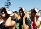 Público do Lollapalooza usa folhetos da programação para se proteger do sol - Reinaldo Canato/UOL