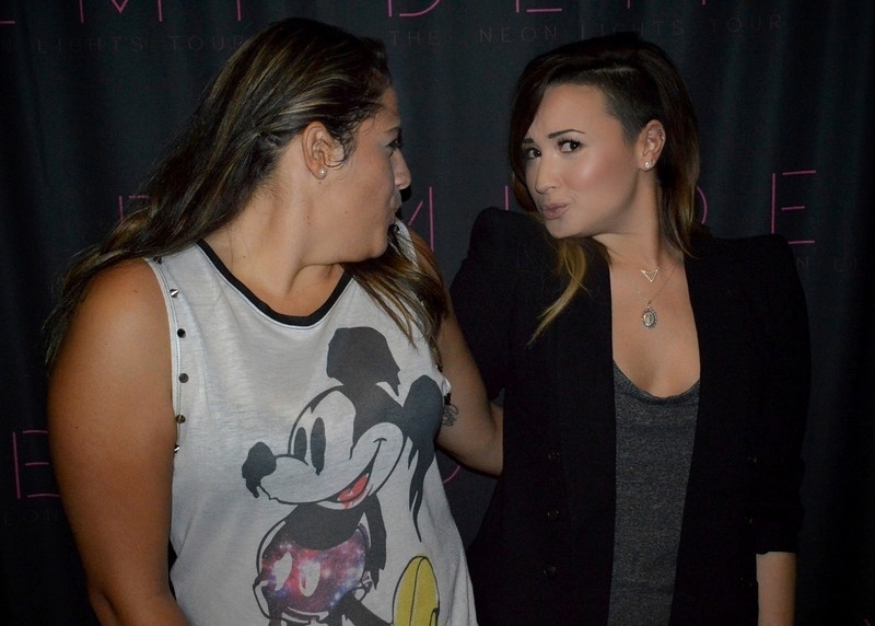 25.abr.2014 - Demi Lovato dá beijinho no ombro em foto com uma fã no camarim de seu show em São Paulo