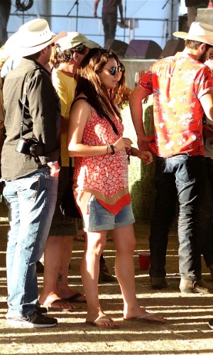 26.abr.2014 - Mila Kunis exibe barriga de grávida durante festival de música country na Califórnia. A filha da atriz com o noivo, o ator Ashton Kutcher, deve nascer em outubro