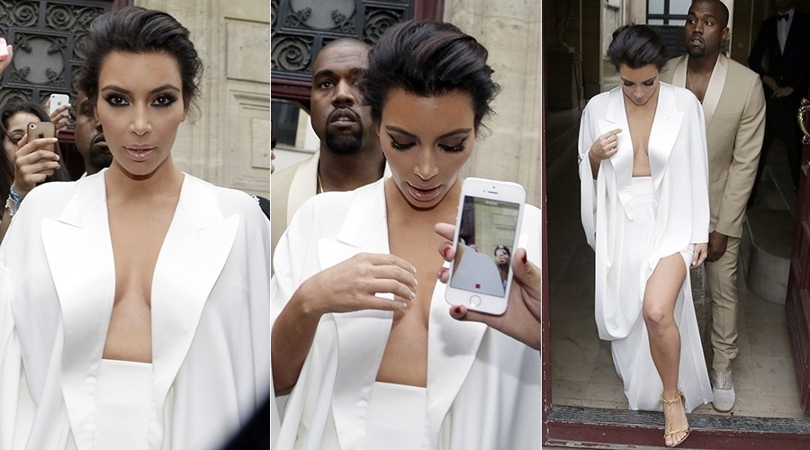23.mai.2014 - Kim Kardashian e Kanye West foram assediados pelos fãs e fotógrafos ao deixarem a residência onde estão hospedados em Paris