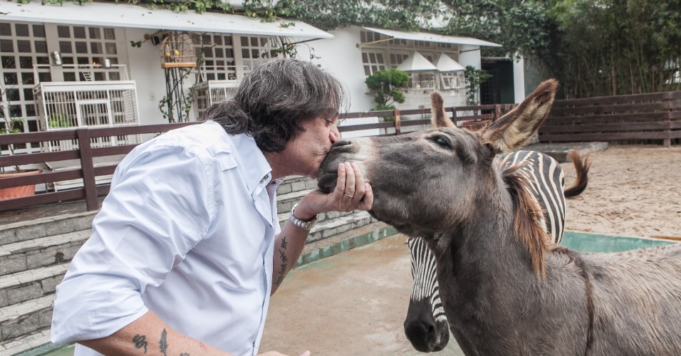 23.mai.2014 - Apaixonado por animais, o cantor e herdeiro da Galeria Pagé, Reinaldo Kherlakian beija o jumento Queco. Em sua casa estão abrigados cerca de 40 animais