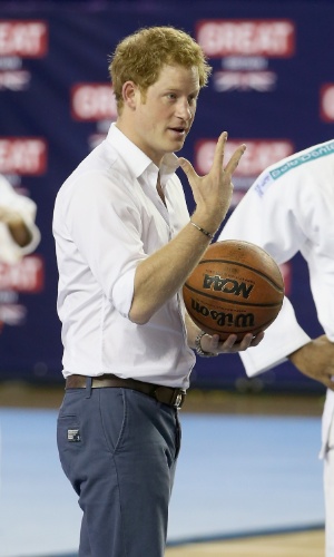 24.jun.2014 - No Minas Tênis Clube, em Belo Horizonte, Príncipe Harry joga basquete e faz pose com a bola