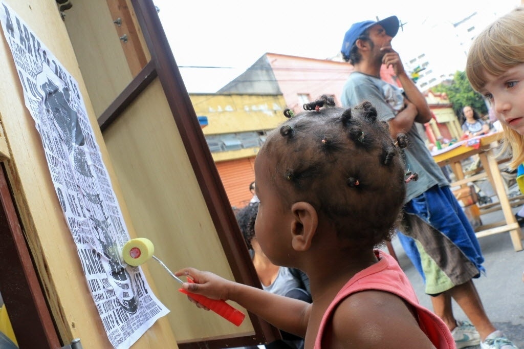 01.jul.2014 - Crianças e adultos do bairro da Luz participam da inauguração do projeto "Cidadania nas Ruas da Luz", em São Paulo. O projeto artístico busca fortalecer os vínculos entre os habitantes e o espaço público do bairro, onde se localiza a zona conhecida como Cracolândia - EFE