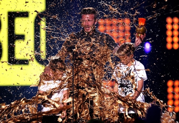 17.jul.2014 - Ao receber o prêmio Nickelodeon Kids' Choice Sports Awards pelo seu trabalho como jogador de futebol e "honra ao seu talento de espírito esportivo", David Beckham ficou tomado por uma gosma jogada no palco do evento, em Los Angeles, nos Estados Unidos