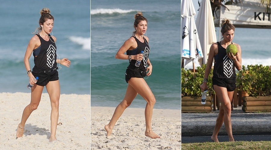 24.jul.2014 - Grazi Massafera correu pelas areias da praia da Barra da Tijuca, zona oeste do Rio. Após o exercício, a atriz se refrescou bebendo água de coco
