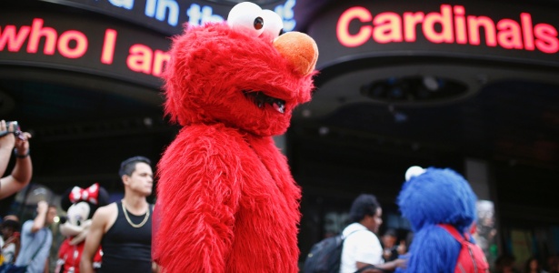 Homem vestido como o personagem Elmo, da "Vila Sésamo", atrai público na Times Square, em Nova York