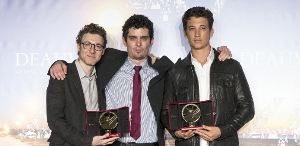 O compositor Nicholas Britell, o diretor Damien Chazelle e o ator Miles Teller posam com o prêmio por "Whiplash" - Etienne Laurent/EFE