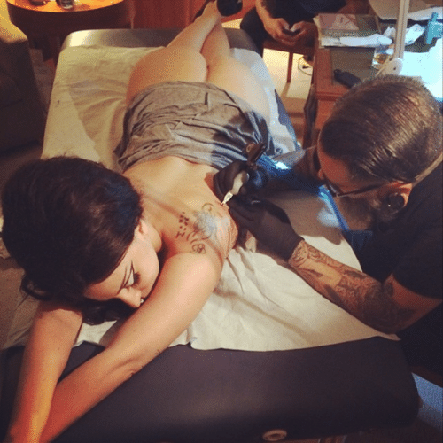 3.out.2014 - Lady Gaga faz nova tatuagem nas costas e mostra o bumbum enquanto está deitada na mesa do tatuador