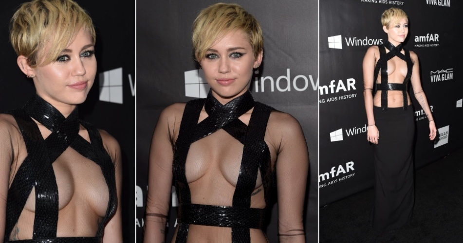 29.out.2014 - Miley Cyrus exibe figurino ousado no baile de gala da amfAR no Milk Studios, em Los Angeles, nos Estados Unidos, na noite desta quarta-feira. A intérprete de "Wrecking Ball" usou um vestido cuja parte de cima é formado basicamente por faixas pretas