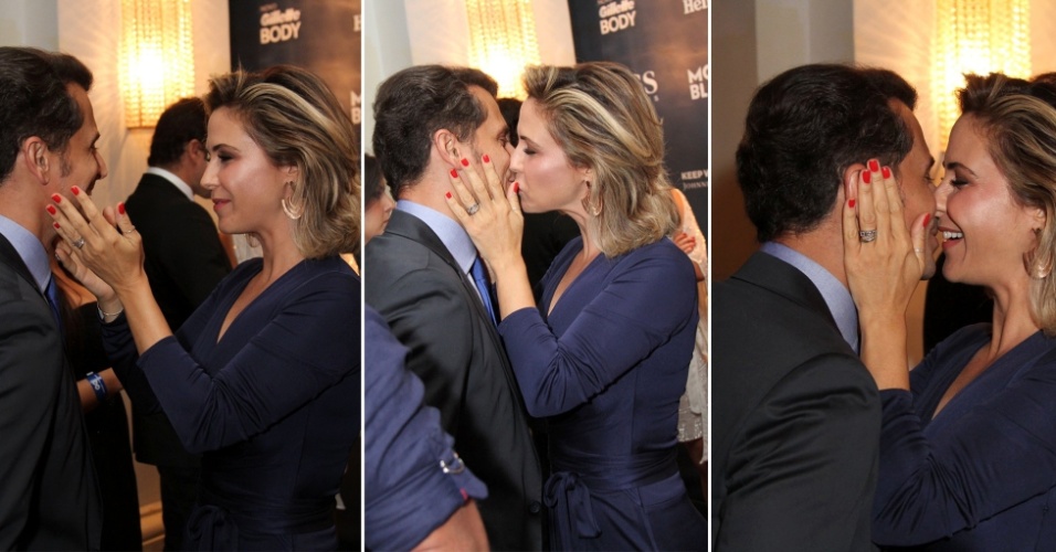 27.nov.2014 - Guilhermina Guinle tasca um beijão em seu marido, Leonardo Antonelli, no 