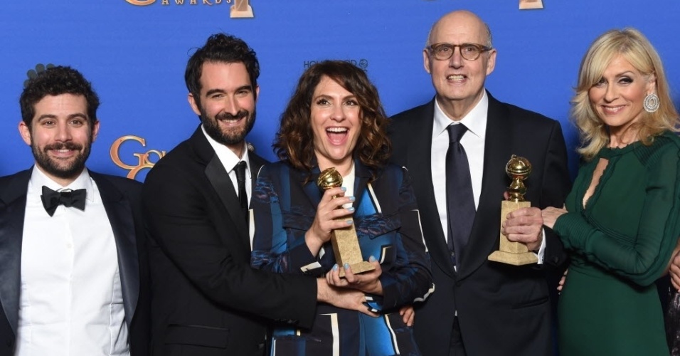 11.jan.2015 - O ator Jeffrey Tambor (de óculos), melhor ator em série de comédia ou musical, e o criador de "Transparent", Jill Soloway,  comemoram com a equipe a estatueta de melhor série de comédia ou musical