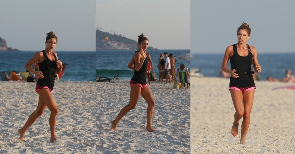 14.jan.2015 - Grazi Massafera aproveitou a temperatura um pouco mais baixa para se exercitar nas areias da praia da Barra da Tijuca, no Rio de Janeiro, na tarde desta quarta-feira. Ao perceber que estava sendo fotografada, a atriz acenou para o paparazzo e seguiu sua caminhada