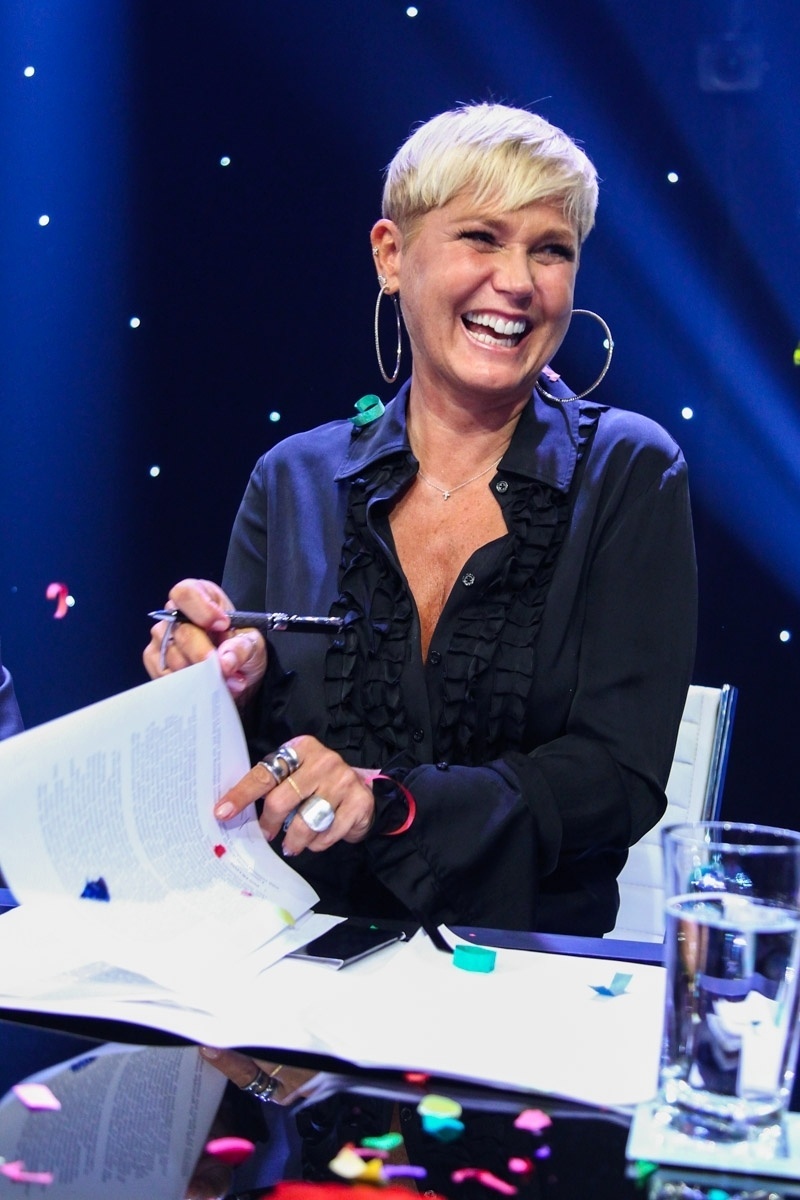 5.mar.2015 - Sorridente, Xuxa assina contrato com a Record na sede da emissora, em São Paulo