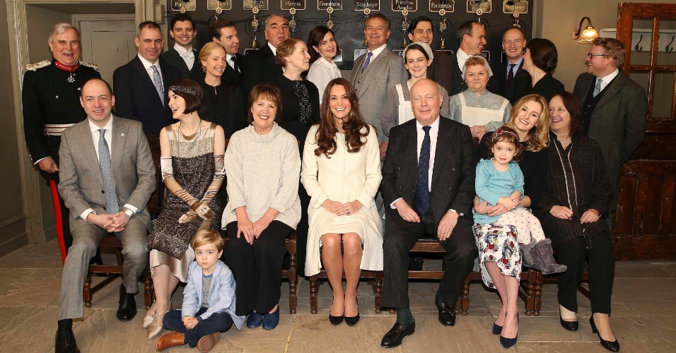 12.mar.2015 - Kate Middleton posa com o elenco e a equipe de "Downton Abbey" durante visita ao set de gravações da série, em Londres