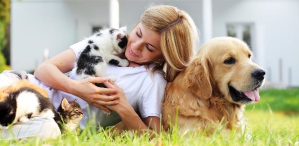 moça na grama com animais de estimação - Getty Images - Getty Images