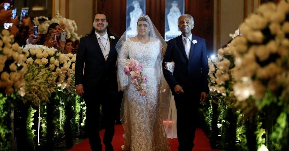 12.mai.2015 - Preta Gil e Rodrigo Godoy se casam no Rio de Janeiro. Na imagem, ela aparece entrando na igreja ao lado do filho e do pai