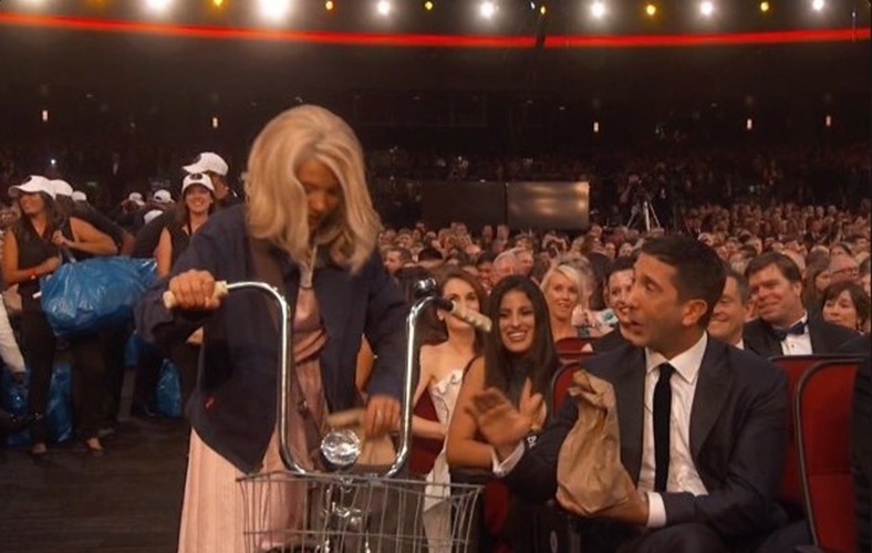 18.set.2016 - Millie Bobby Brown, a Onze de "Stranger Things", entrega comida para a plateia do Emmy ao lado dos colegas de série Gaten Matarazzo e Caleb McLaughlin. Os três estavam caracterizados como seus personagens da série da Netflix - Reprodução/Twitter/EW