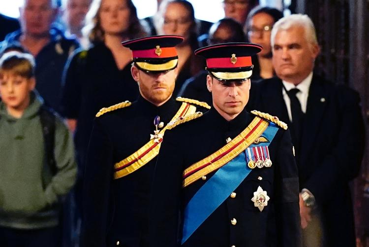 Harry and William at the vigil in honor of Queen Elizabeth II;  initials "ER" appear on William's shoulders, while Harry's uniform has the letters removed - Getty Images - Getty Images