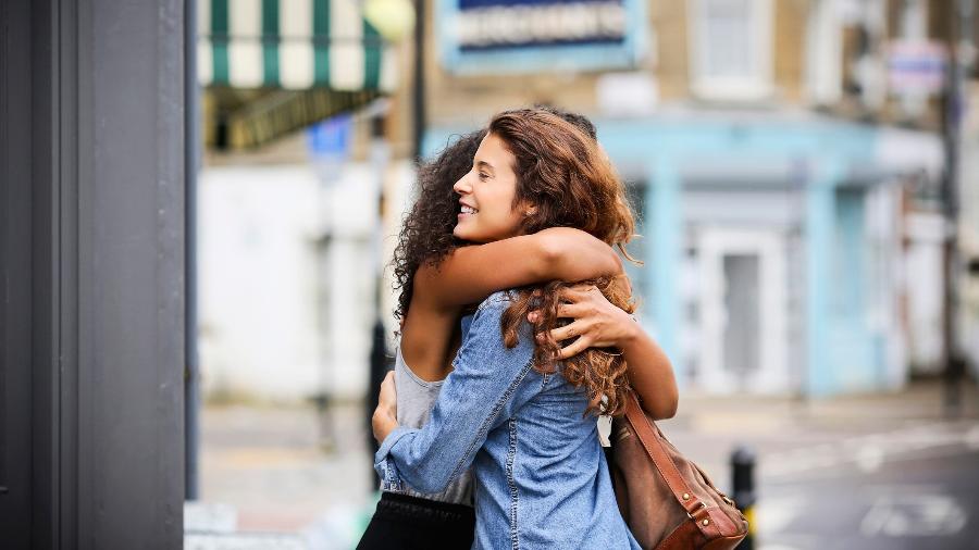 Amigas se abraçam para comemorar aniversário - Getty Images