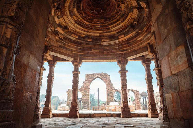 The iron column still stands next to the mosque and other monuments in the Qutb Minar complex.