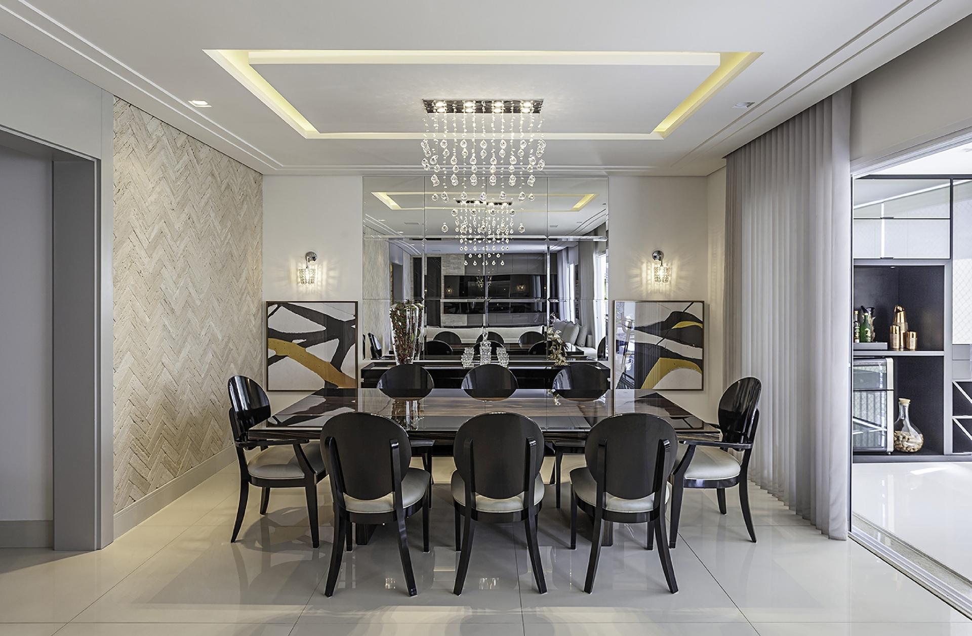 Na sala de jantar, a arquiteta Cristiane Schiavoni usou a iluminação para criar diversos cenários. Controlada por dimmer (dispositivo usado para variar a intensidade de uma corrente elétrica), a luz geral, composta por spots no teto, pode ser intensa ou suave. Spots periféricos, rentes à parede, destacam o revestimento (Lepri). Sobre a mesa de jantar, o pendente emite uma luz mais intensa e direta - Carlos Piratininga/Divulgação