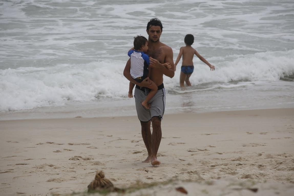 27.nov.2016- Felipe Simas se refresca no mar da Barra da Tijuca, no Rio,  com o filho Joaquim - Ag.News