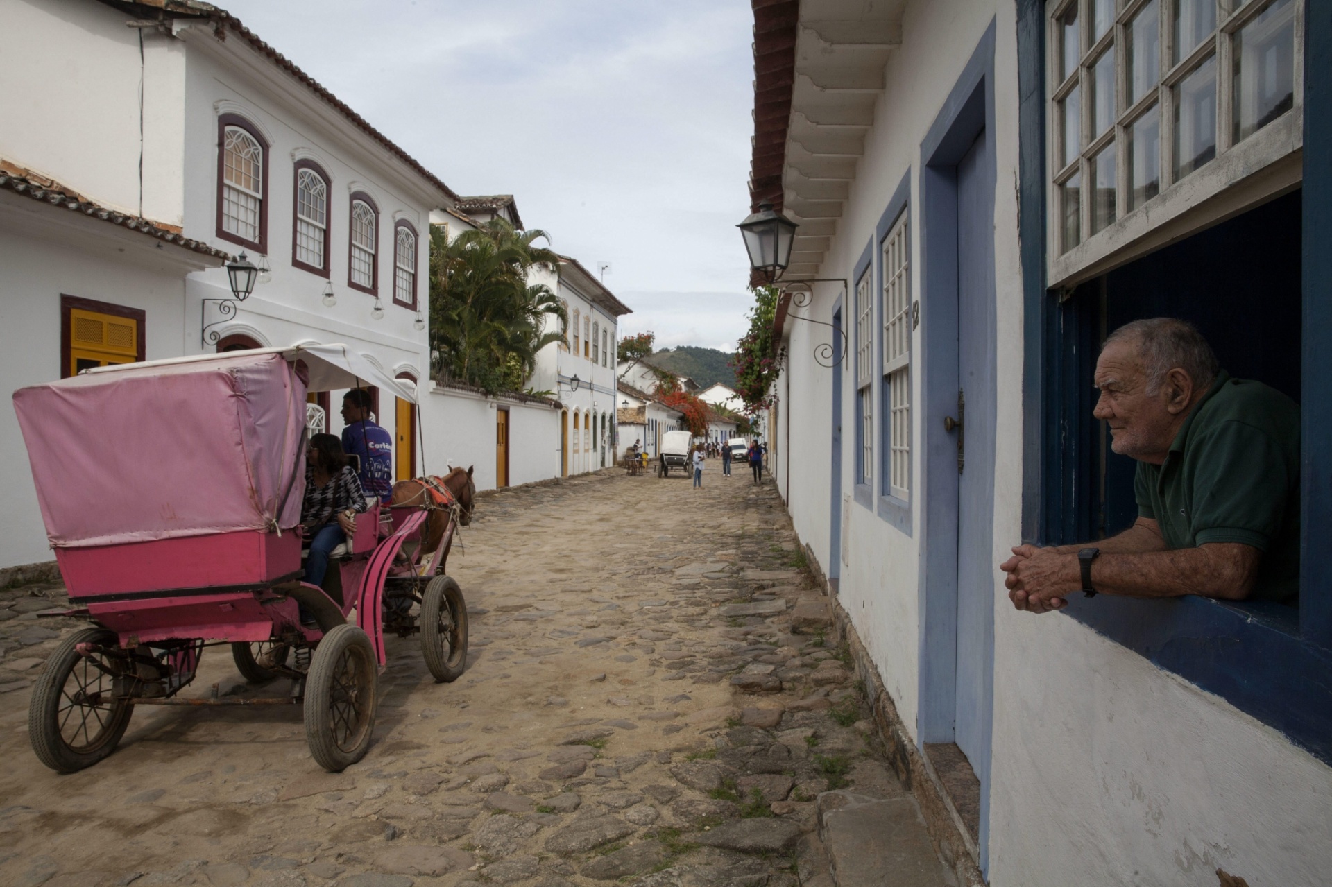 2.jul.2015 - Homem observa um grupo de turistas no centro histórico de Paraty durante a realização da 13ª edição da Flip, Festa Literária Internacional de Paraty. - Sebastião Moreira