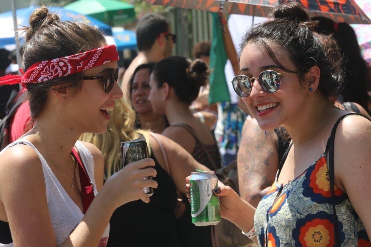 18.set.2015- Fãs tomam cerveja para espantar o calor na entrada da Cidade do Rock - Zulmair Rocha/UOL