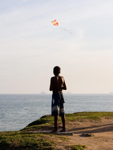 Menino empina pipa de frente para o mar de Ipanema, no Rio - Getty Images/iStockphoto