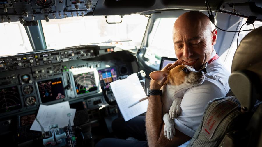 Piloto da Southwest Airlines com um dos cães resgatados no Havaí que deixou Maui após o incêndio florestal