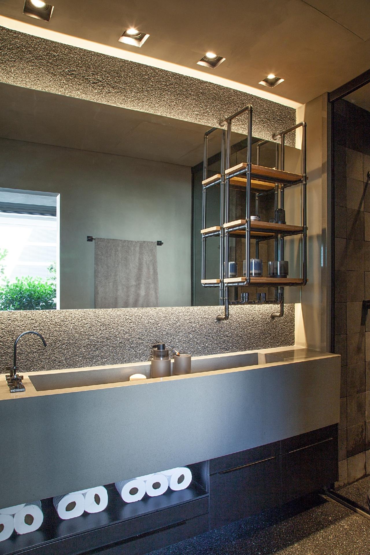 Com uma pegada mais industrial e atemporal, a suíte do loft de um jovem solteiro ganhou uma pequena estante metálica suspensa. A peça surpreende por ser montada com tubos e conexões, posteriormente pintados de preto fosco, e prateleiras de madeira de demolição. E só! Executada pela Keyato Ferragens, mede 33 x 20 x 70 cm e é assinada pela arquiteta Pati Cillo. - Luis Gomes