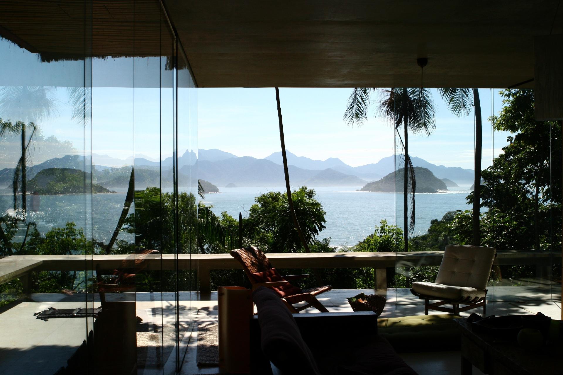 Com uma arquitetura estilosa, essa casa de vidro já foi capa de duas publicações internacionais de design. Localizada a apenas 70m da praia do Félix, possui uma vista para o mar de todas as suas quatro suítes ou dos 200m de deck de madeira ao redor.    - Divulgação/Airbnb