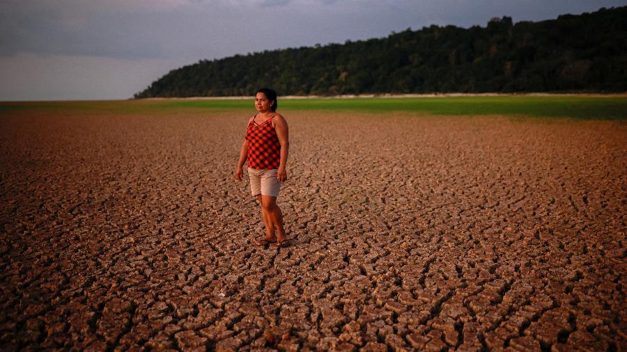 Mulher caminha pelo leito seco de afluente do rio Tapajós, na Amazônia