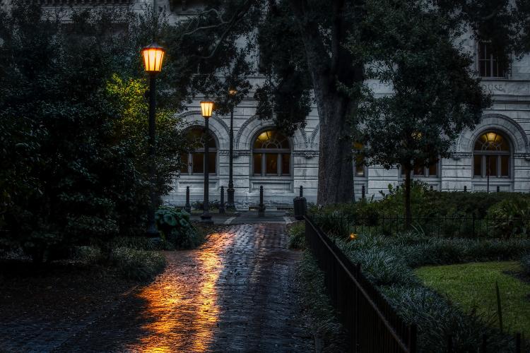 Lamps reflecting off of a wet brick walkway at night in a dark square in Savannah, Georgia. - Glen Richard/Getty Images/iStockphoto - Glen Richard/Getty Images/iStockphoto