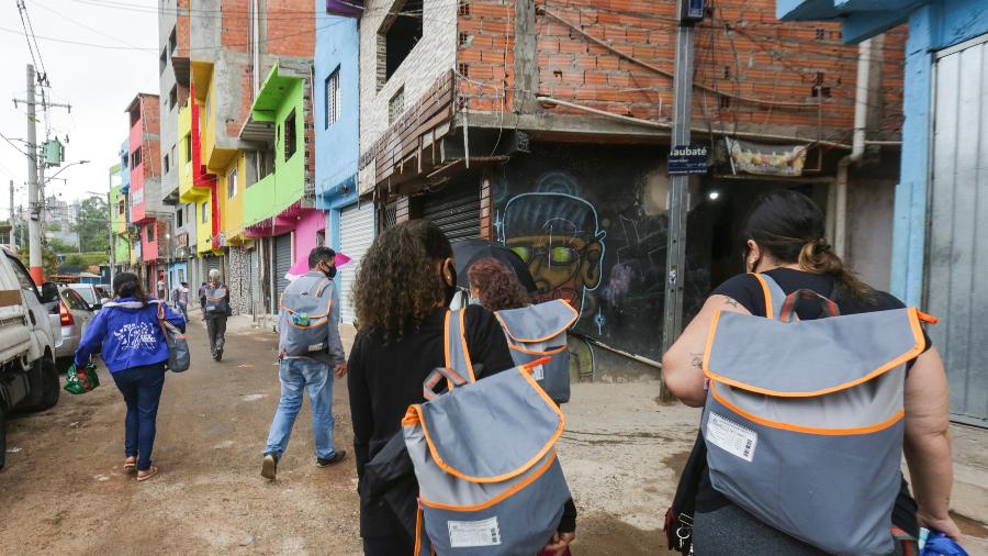Moradores de Paraisópolis voltam para suas casas após receber kit com congelados para o Natal doado pelo Grupo UOL - Ricardo Matsukawa/UOL