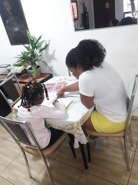 A corretora de imóveis Tatiane Cristina ajuda a filha de sete anos com as aulas durante a quarentena - Magda Souza/UOL