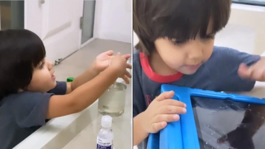 Artur, 3 anos, passa álcool em gel no tablet - Reprodução/Instagram
